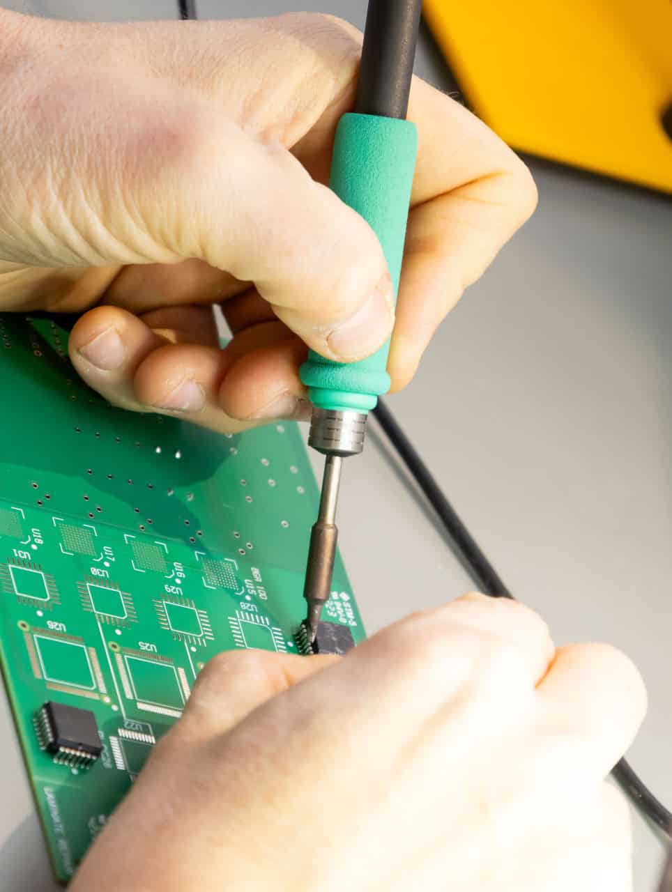 a course participant soldering a circuit board